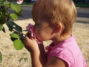 Child stopping to smell the roses