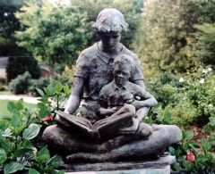 Statue of mother reading to child